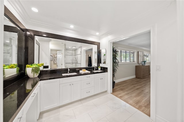 bathroom featuring vanity, crown molding, wood-type flooring, and walk in shower