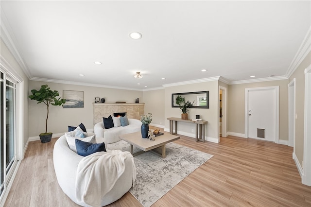 living room with ornamental molding and light hardwood / wood-style floors