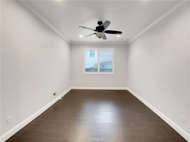 spare room featuring ceiling fan, ornamental molding, and dark hardwood / wood-style flooring