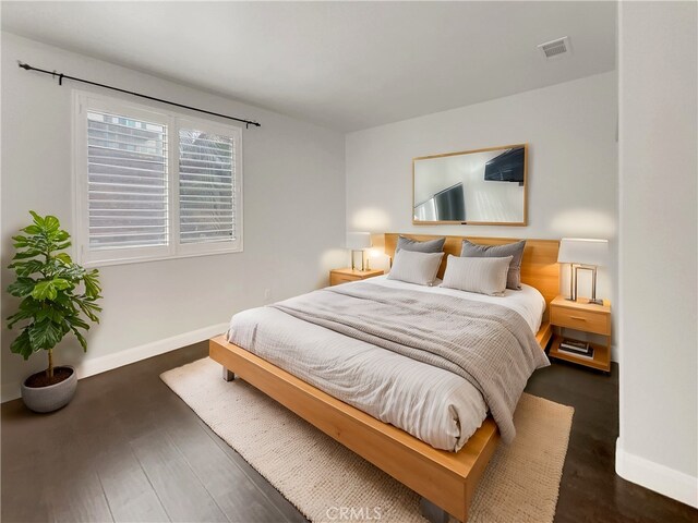 bedroom featuring dark hardwood / wood-style flooring