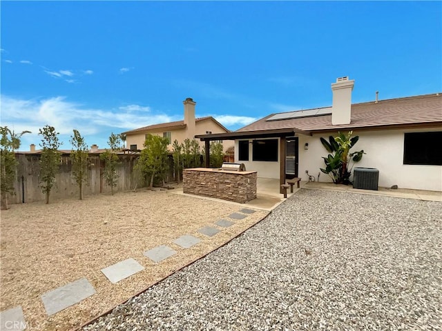 back of house with a patio, area for grilling, a fenced backyard, ceiling fan, and central AC