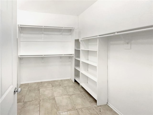 spacious closet with light tile patterned floors