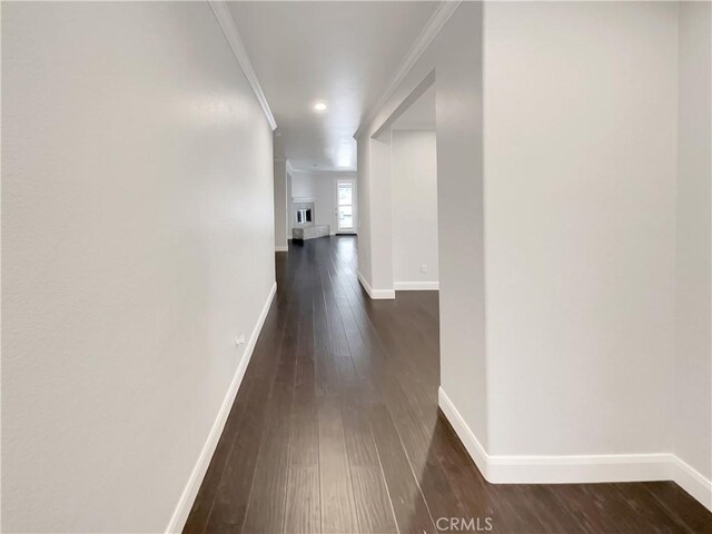 hall with crown molding and dark hardwood / wood-style floors