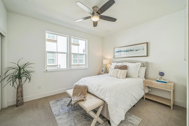 bedroom featuring light colored carpet and ceiling fan