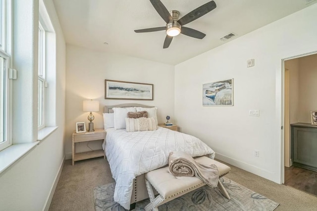 bedroom featuring light carpet and ceiling fan