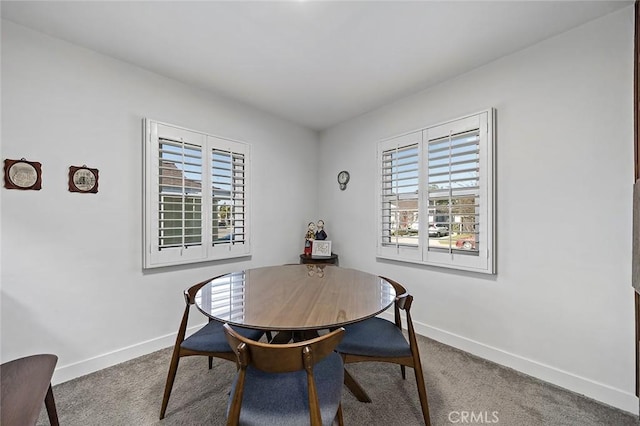 dining area featuring carpet flooring