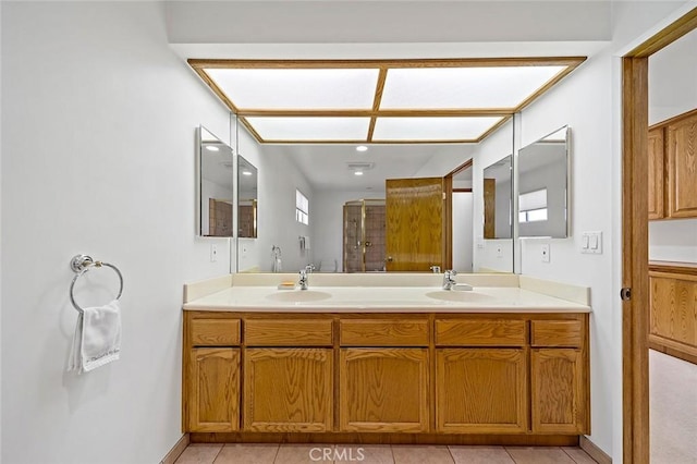 bathroom featuring vanity, an enclosed shower, and tile patterned floors