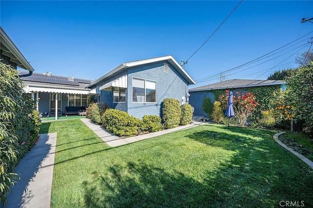 exterior space with a lawn and solar panels