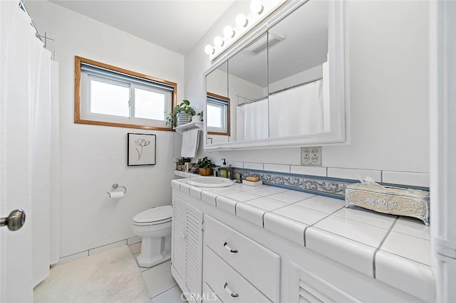 bathroom with vanity, tile patterned floors, and toilet