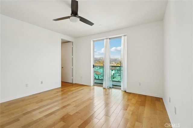 empty room featuring wood-type flooring and ceiling fan