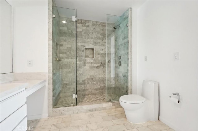 bathroom with vanity, toilet, and a shower with shower door