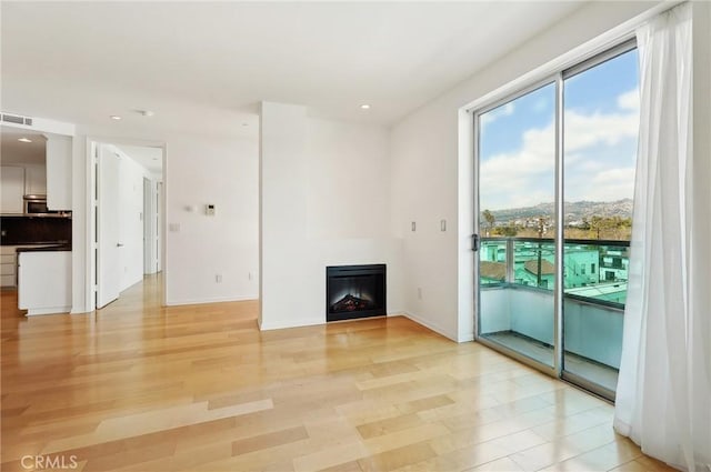 unfurnished living room with light wood-type flooring