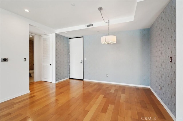 unfurnished room with hardwood / wood-style floors