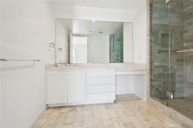 bathroom with vanity and a shower with door