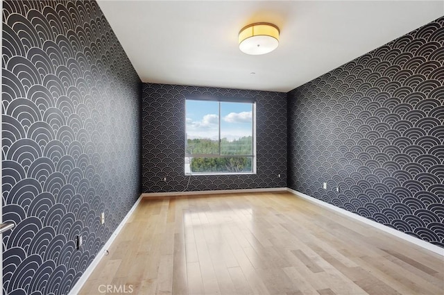 spare room with light hardwood / wood-style flooring