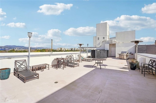 view of patio with a mountain view and area for grilling