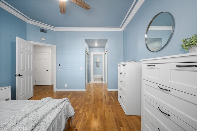 bedroom featuring crown molding, ceiling fan, and light hardwood / wood-style floors