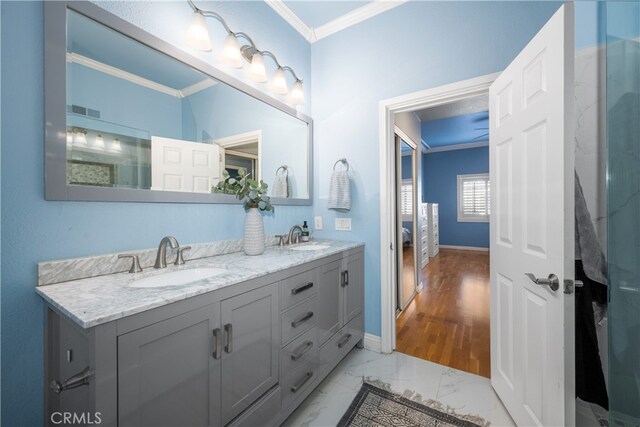 bathroom featuring crown molding and vanity