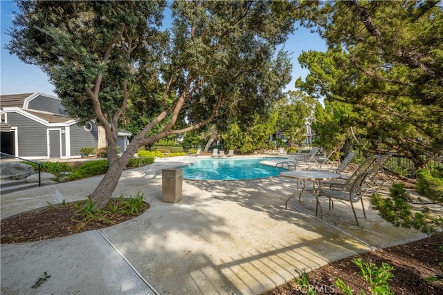 outdoor pool with a patio area