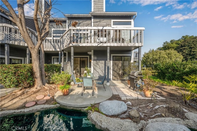 rear view of property featuring a patio area