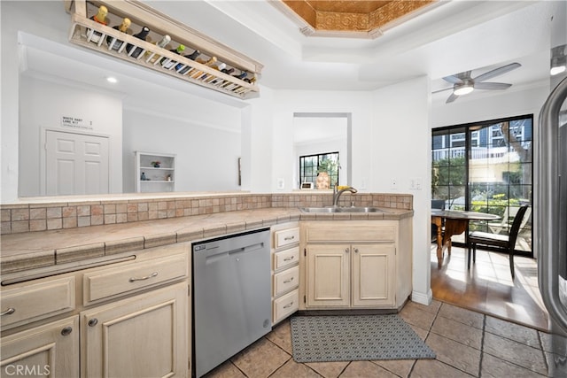 kitchen featuring crown molding, a sink, and stainless steel dishwasher