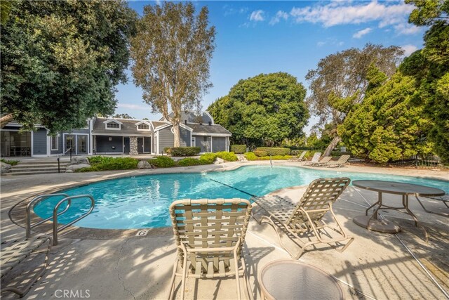 view of swimming pool with a patio area