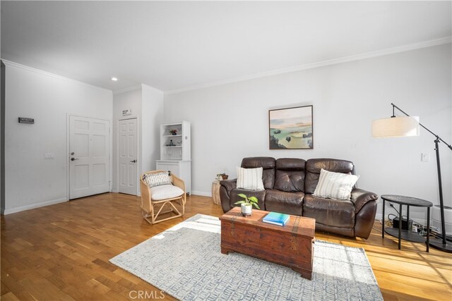 living room featuring crown molding and hardwood / wood-style floors