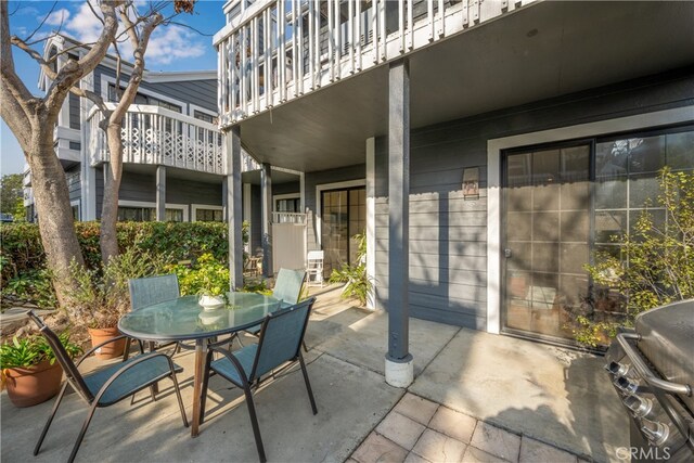 view of patio / terrace featuring a grill and a balcony