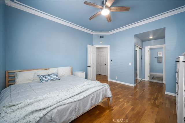 bedroom featuring wood finished floors, a ceiling fan, visible vents, baseboards, and ornamental molding