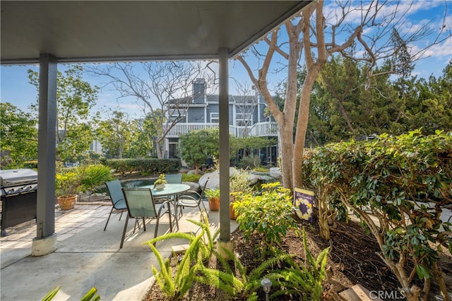 view of patio / terrace featuring outdoor dining space and a grill