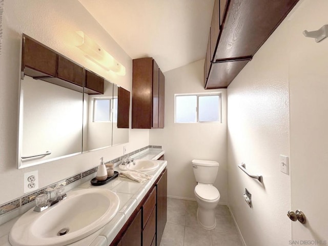 bathroom featuring vaulted ceiling, vanity, toilet, and tile patterned flooring