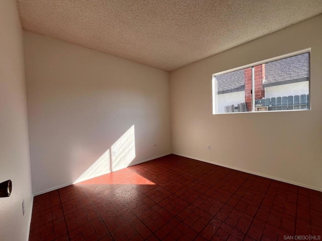 spare room with a textured ceiling