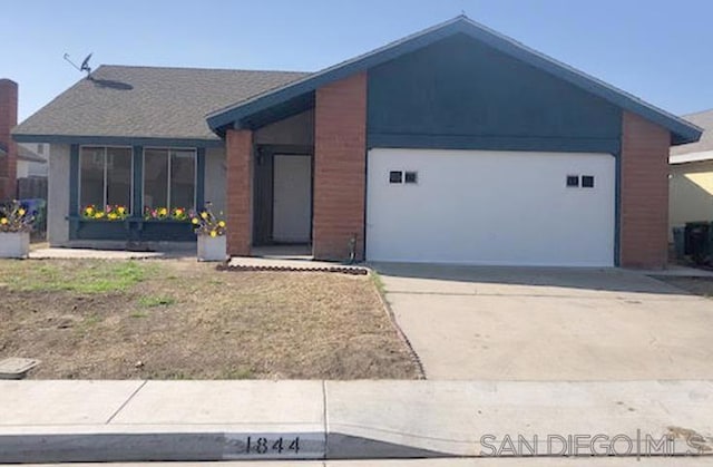 single story home featuring a garage