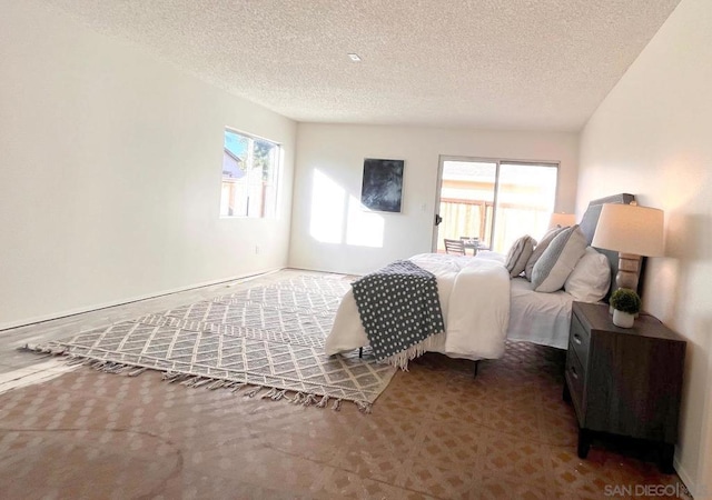 bedroom featuring carpet and a textured ceiling