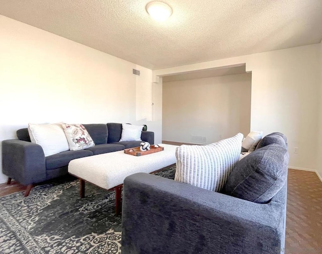 carpeted living room with a textured ceiling