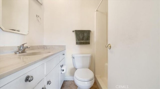 bathroom featuring vanity, toilet, and a shower