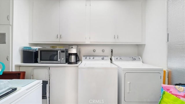 clothes washing area featuring washer and dryer