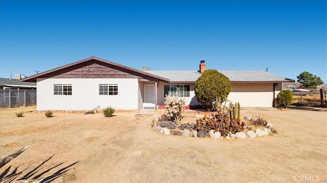 ranch-style home featuring a garage