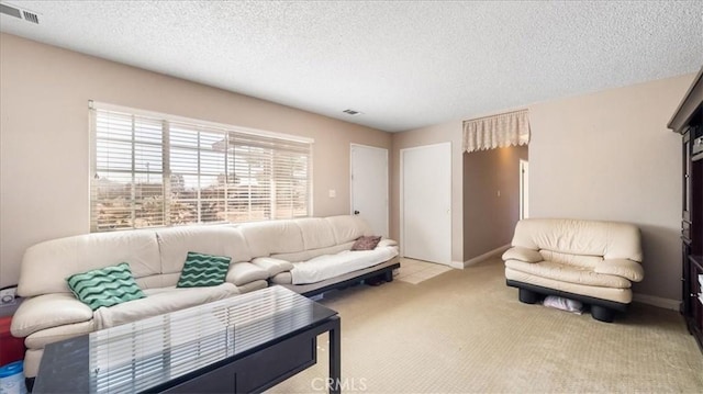 living room featuring light carpet and a textured ceiling