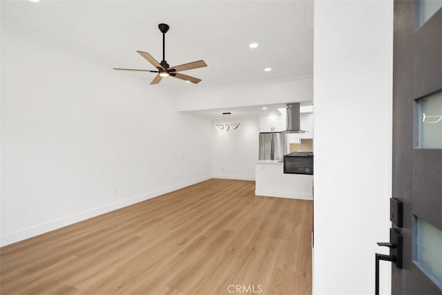 unfurnished living room with crown molding, ceiling fan, and light hardwood / wood-style flooring