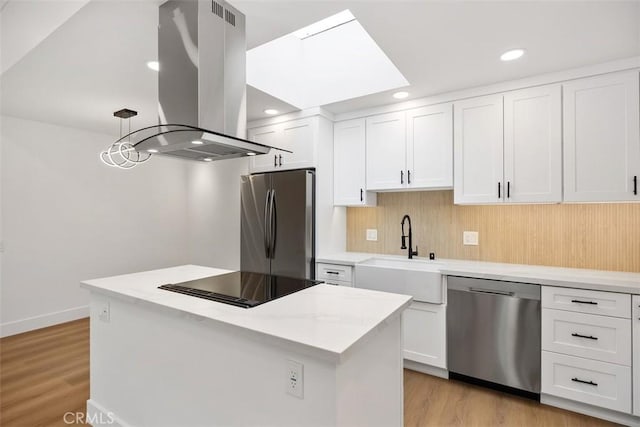 kitchen featuring white cabinetry, stainless steel appliances, and island range hood