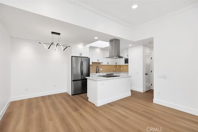 kitchen with a kitchen island, island range hood, decorative light fixtures, white cabinets, and stainless steel appliances