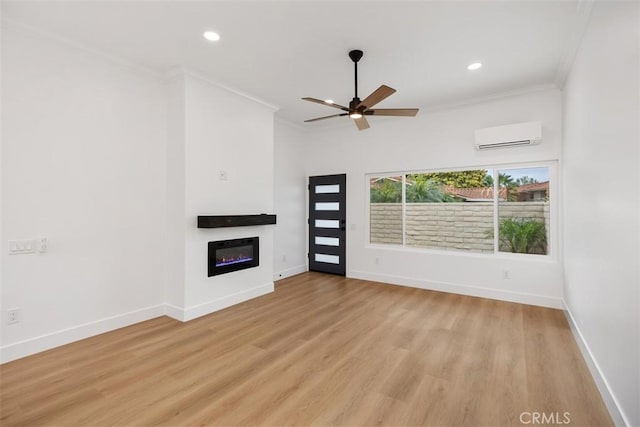 unfurnished living room featuring crown molding, ceiling fan, a wall unit AC, and light hardwood / wood-style floors