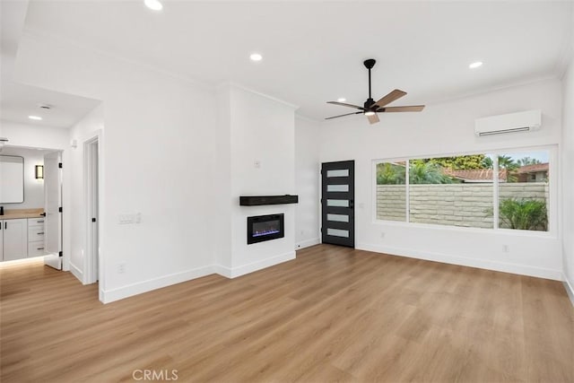 unfurnished living room with crown molding, light hardwood / wood-style flooring, and a wall unit AC