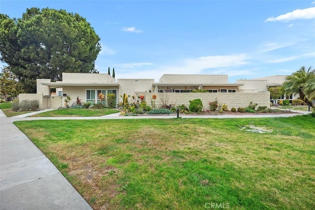 ranch-style home with a front lawn