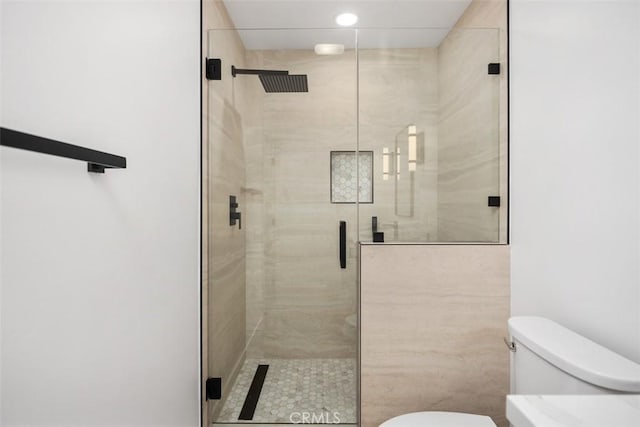 bathroom featuring toilet and walk in shower