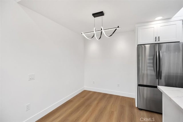 interior space featuring a chandelier and light wood-type flooring