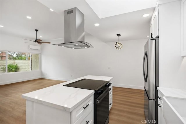 kitchen with stainless steel refrigerator, black electric range oven, white cabinets, hanging light fixtures, and island exhaust hood