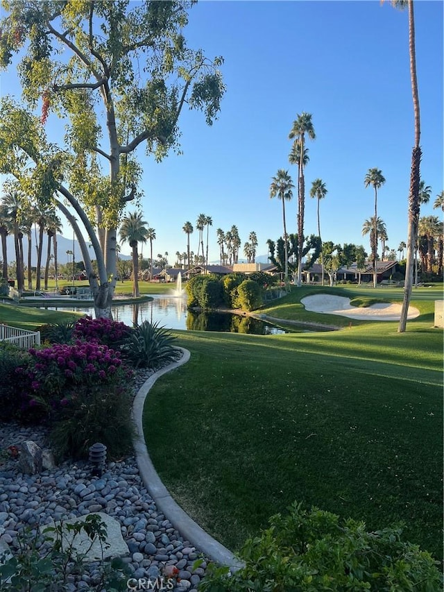 view of community featuring a water view and a lawn