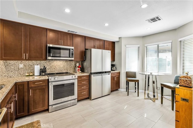 266 Running Springs Dr, Palm Desert, CA 92211 - kitchen featuring appliances with stainless steel finishes, backsplash, light stone countertops, recessed lighting, and baseboards